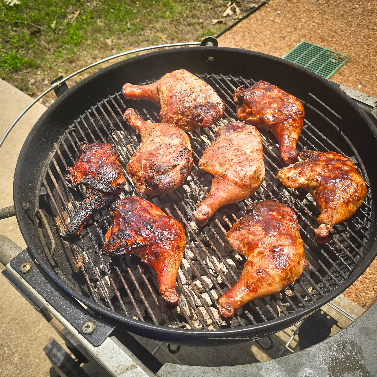Pasture-raised chicken legs sizzling on the grill with a smoky barbecue glaze — farm-fresh, antibiotic-free meat from Copper Branch Farm.